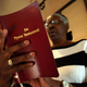 Ervena Faulkner, the co-manager of history and culture at the Penn Center, holds a copy of “De Nyew Testament,” Nov. 9, 2005, in St. Helena Island, S.C. The New Testament has been translated into Gullah, the creole language spoken by slaves and their descendants for generations along the Sea Islands of the Southeast coast. (Stephen Morton/AP Images)